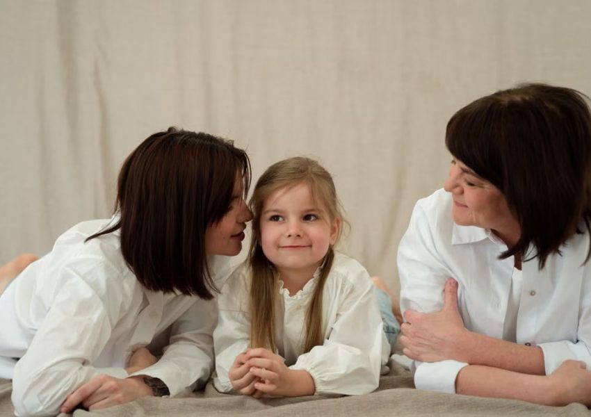 Three generations of women smiling together, symbolizing familial love and connection.